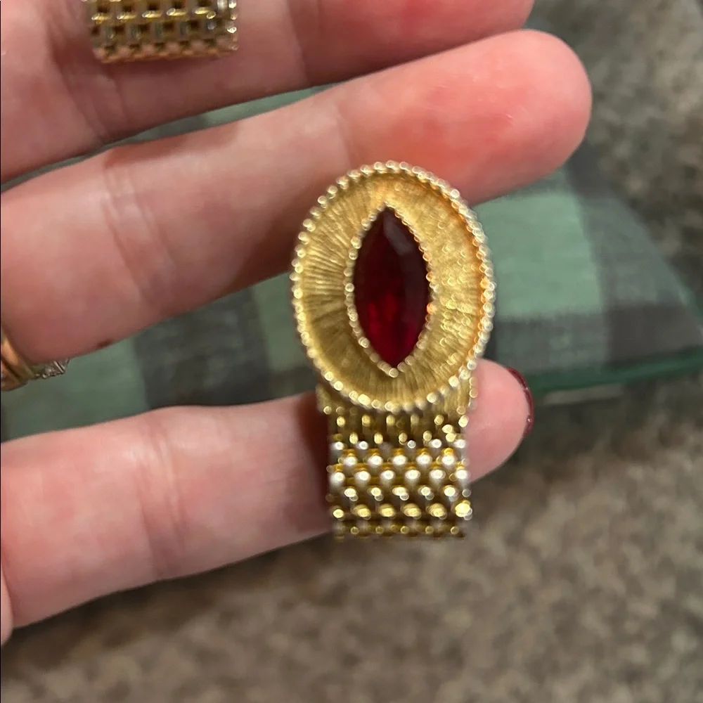 vintage gold-tone woven mesh cufflink with a red rhinestone center.